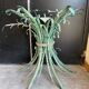Vintage console in patinated metal with reed leaves.