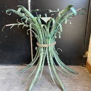 Vintage console in patinated metal with reed leaves.