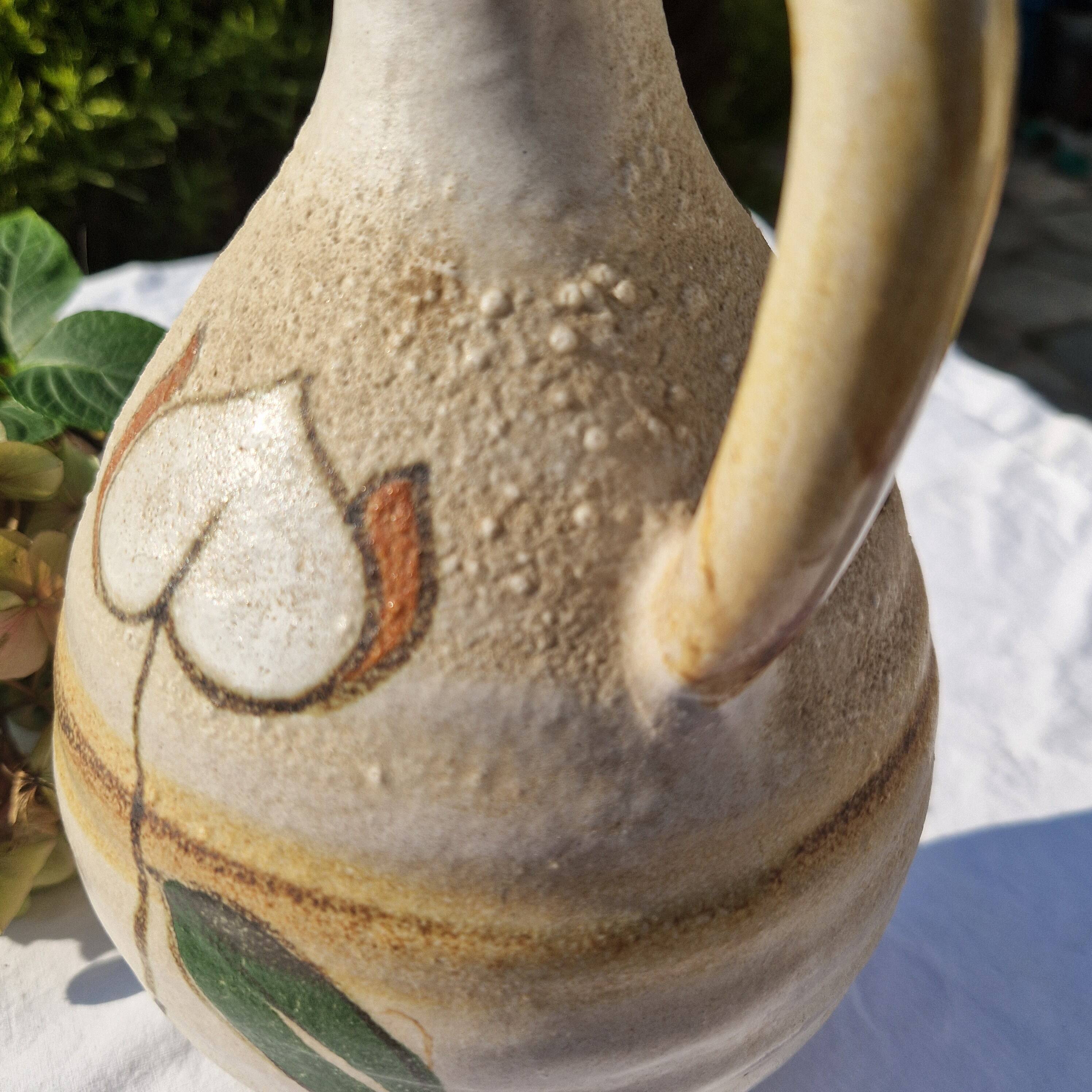 Handcrafted jug or jar with a handle, terracotta pottery vase, fat lava effect, stylized flowers