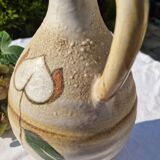 Handcrafted jug or jar with a handle, terracotta pottery vase, fat lava effect, stylized flowers
