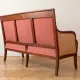 Restoration Empire period canapé bench in carved mahogany.