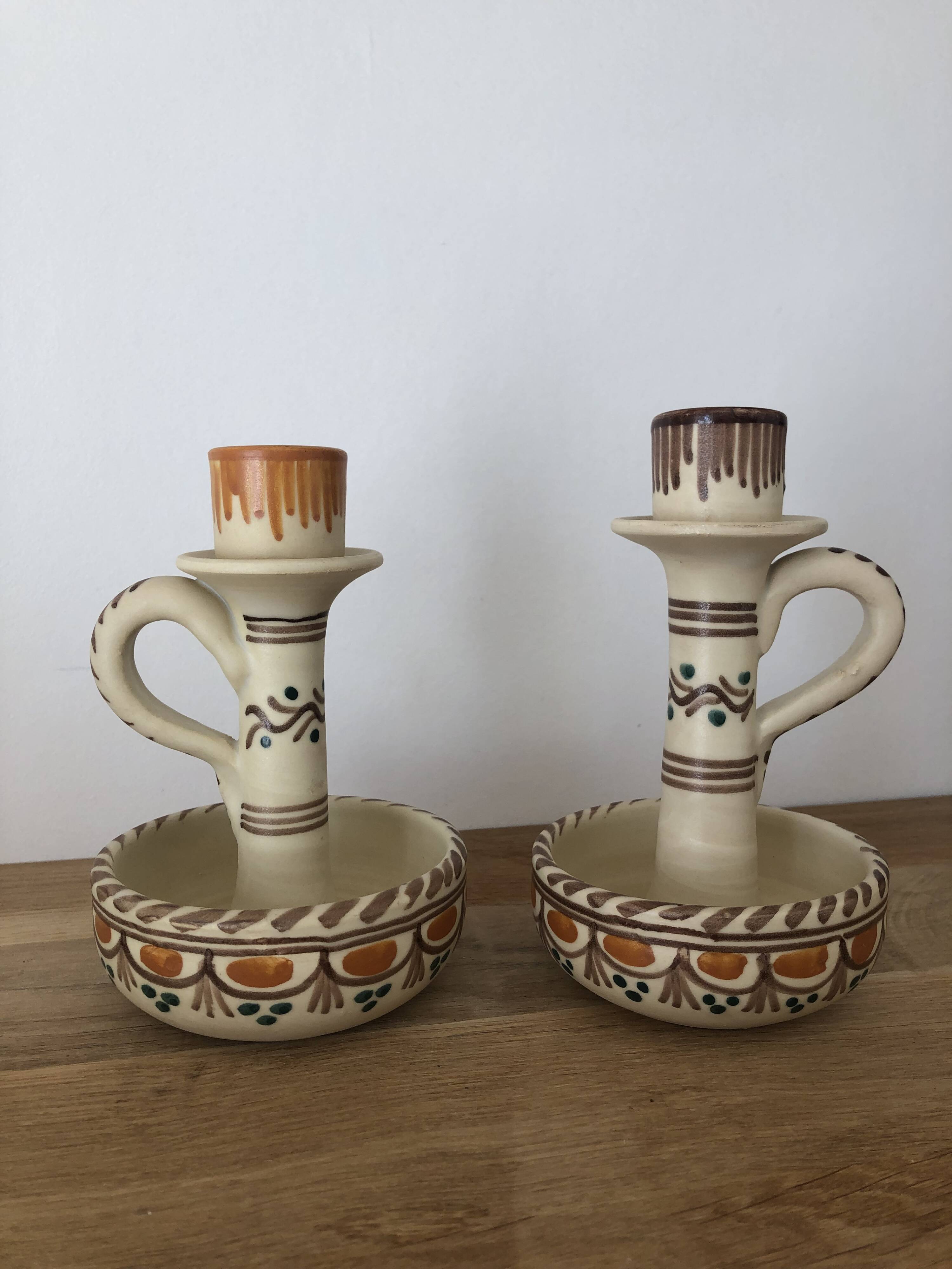 Set of two candlesticks/candle holders in orange and brown tones