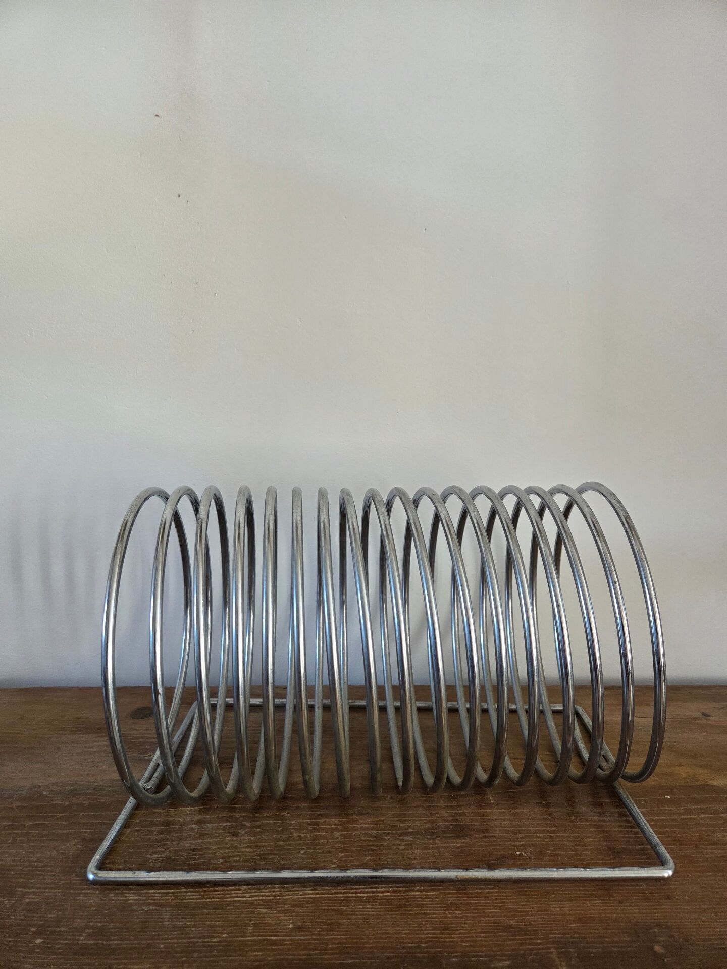 Chrome spring magazine rack, 1970