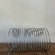 Chrome spring magazine rack, 1970