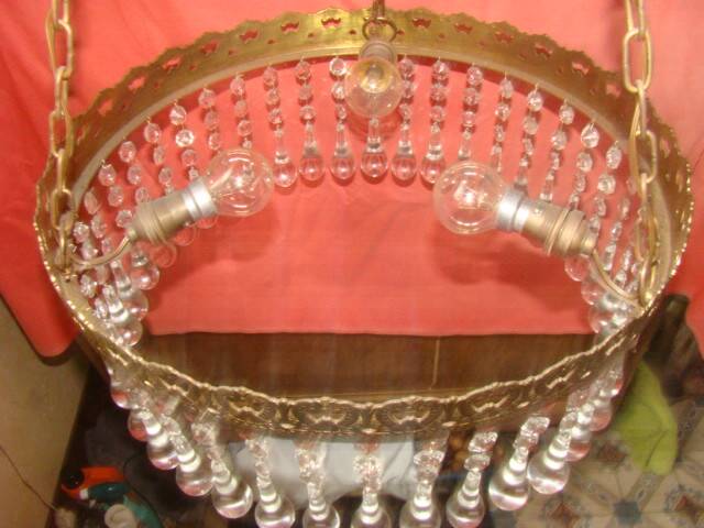 circular chandelier with a brass frame and crystal drops