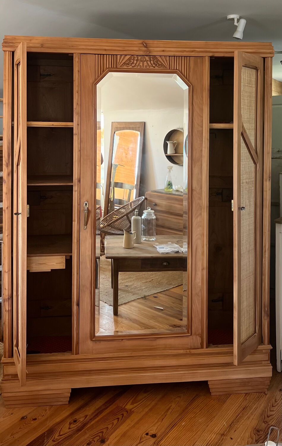 Large antique wardrobe made of solid raw wood and natural caning.