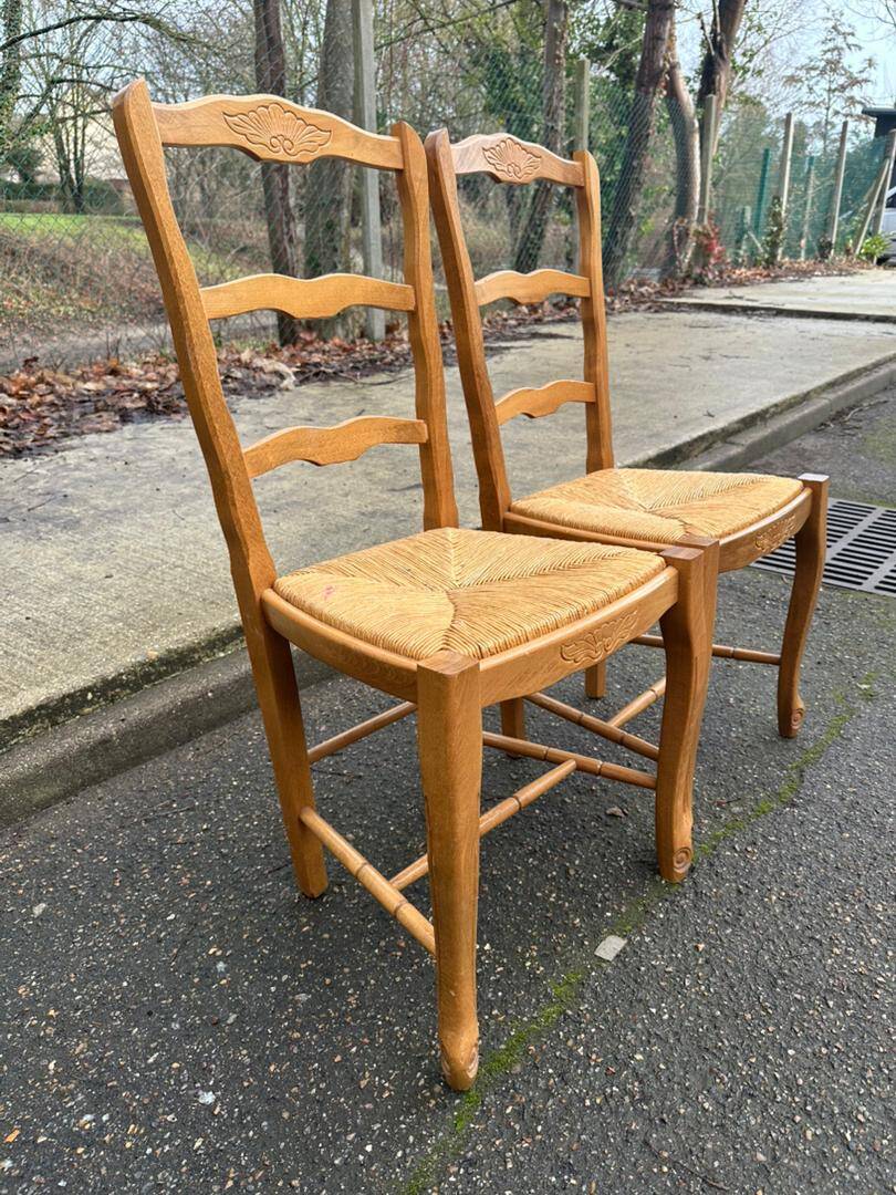 2 solid wood and rush-seated chairs in Louis XV style with shell carving from the 20th century.