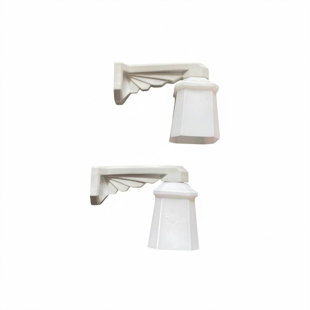 Pair of Art Deco wall sconces in ceramic with opaline glass shades.