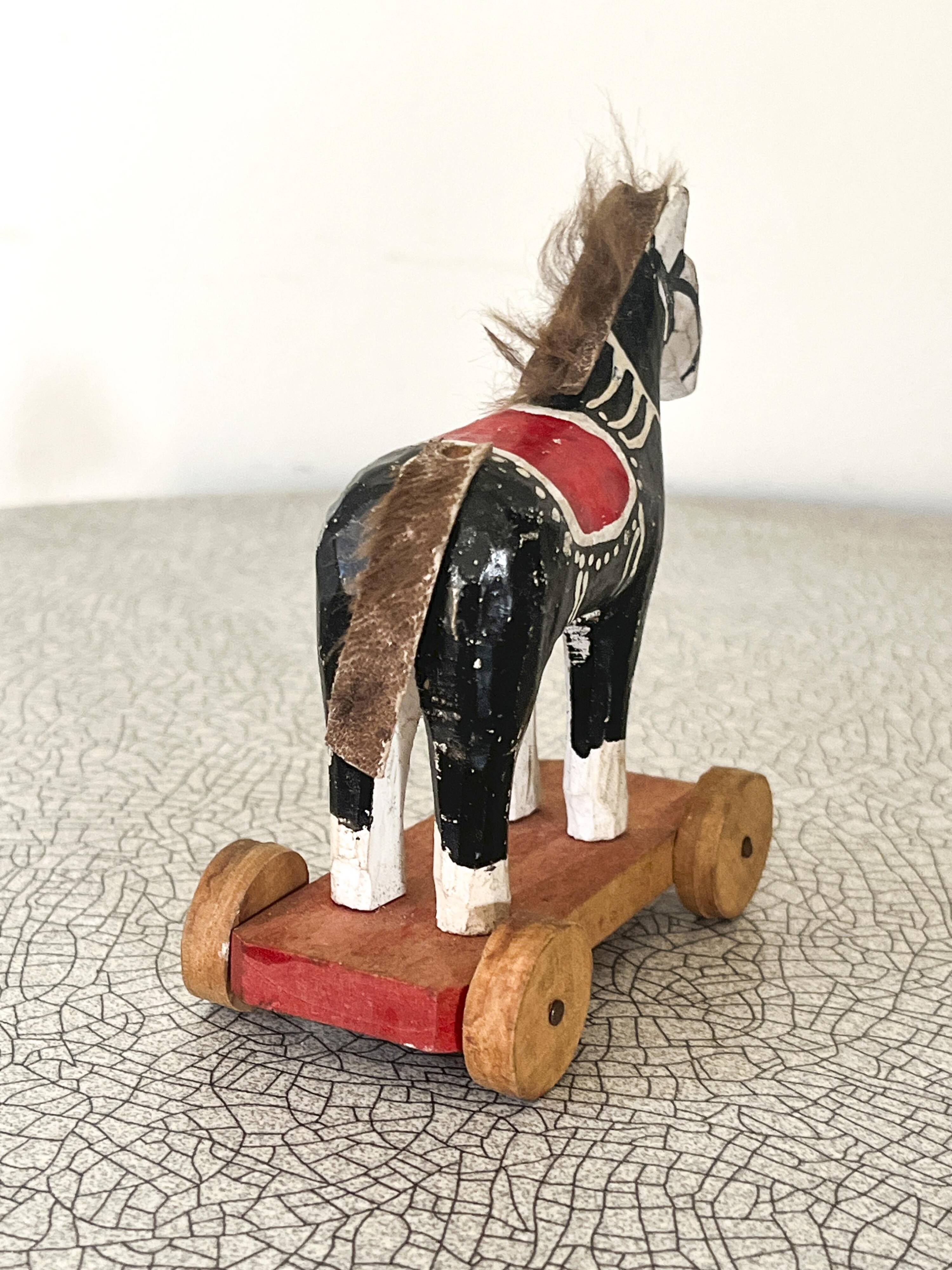 Old wooden pull-along toy, horse.