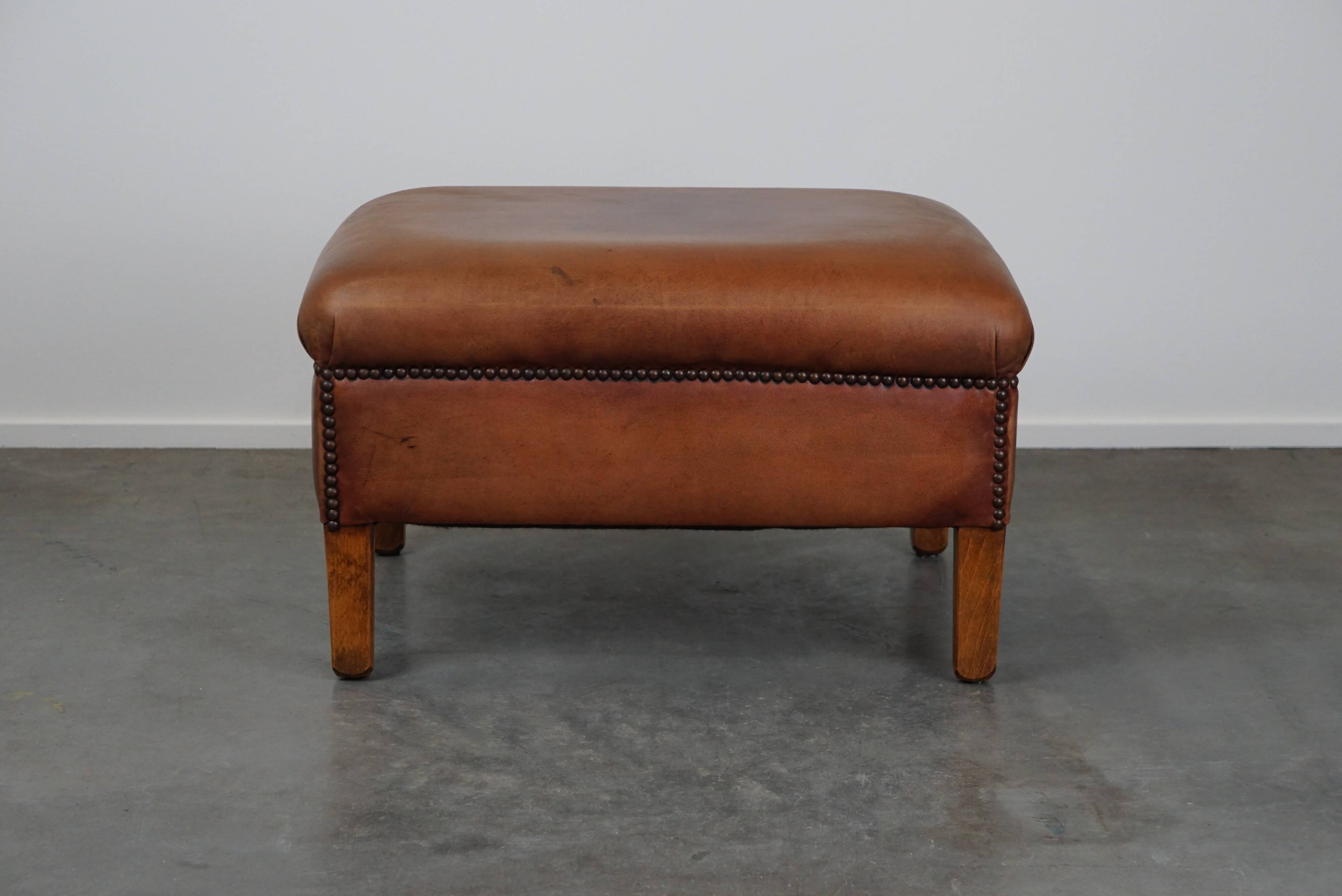 English-style leather ottoman in cognac-colored leather