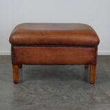 English-style leather ottoman in cognac-colored leather