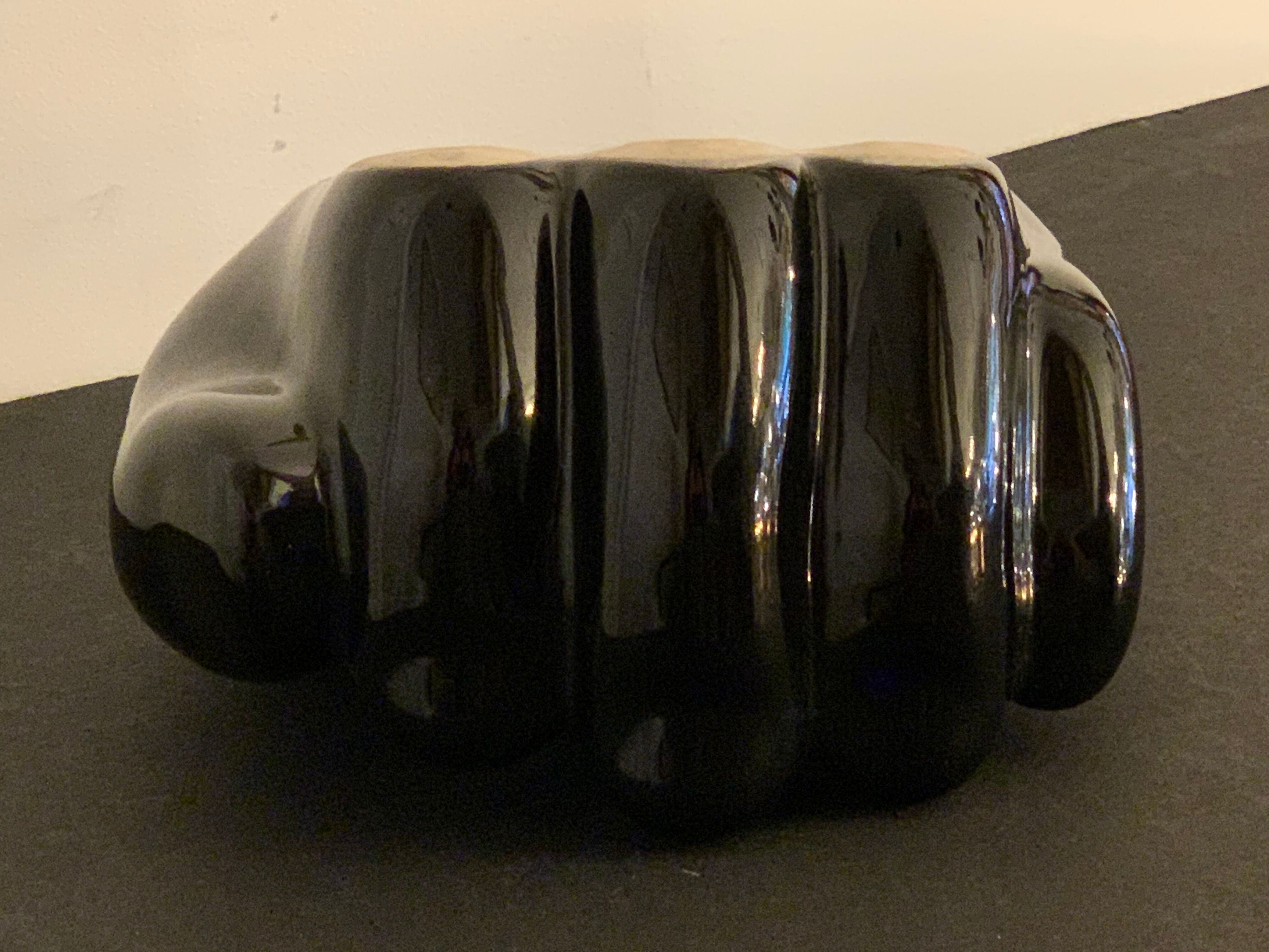Black ceramic ashtray left hand