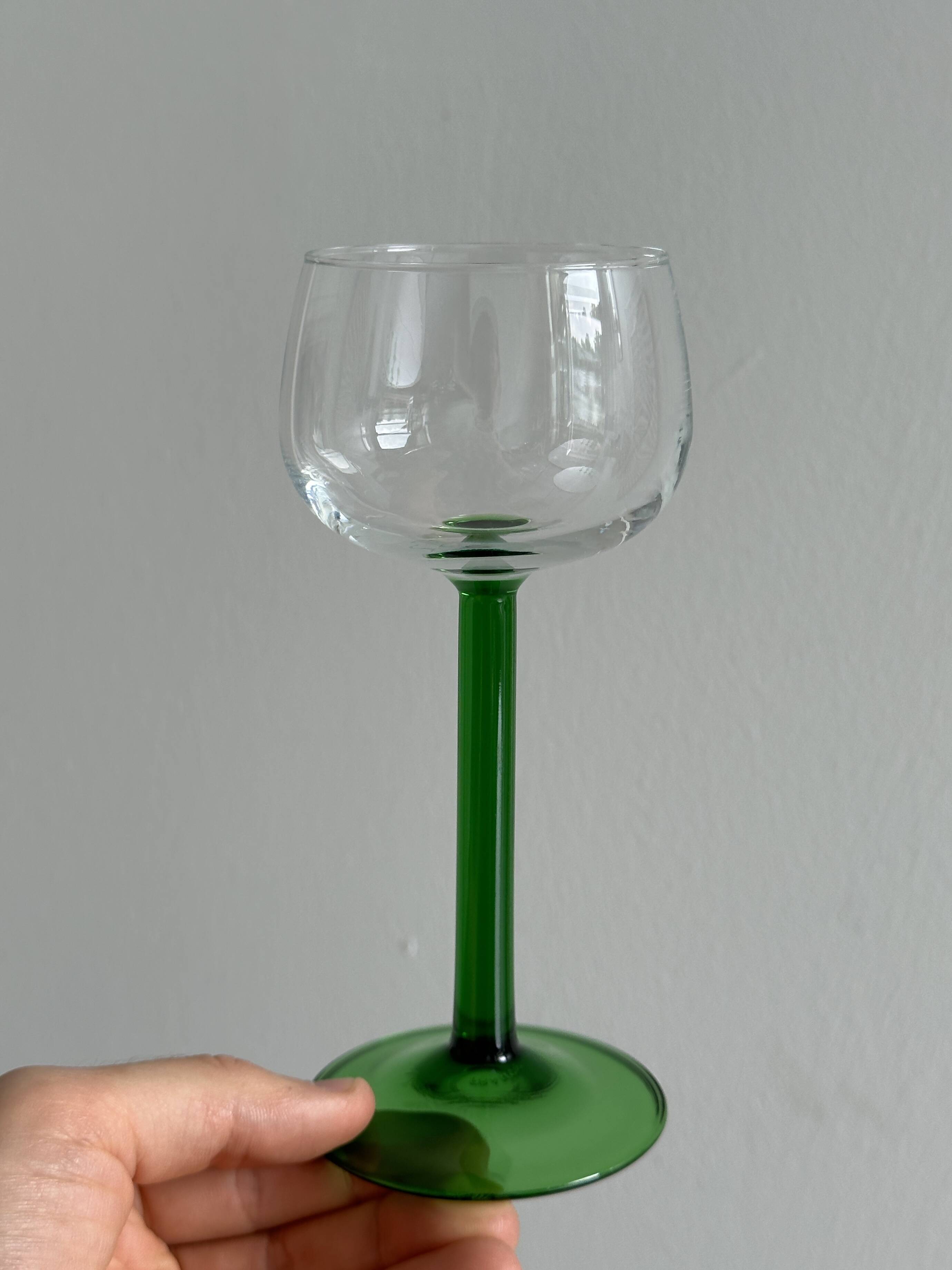 8 Alsatian stemmed glasses, transparent glass and green stems.