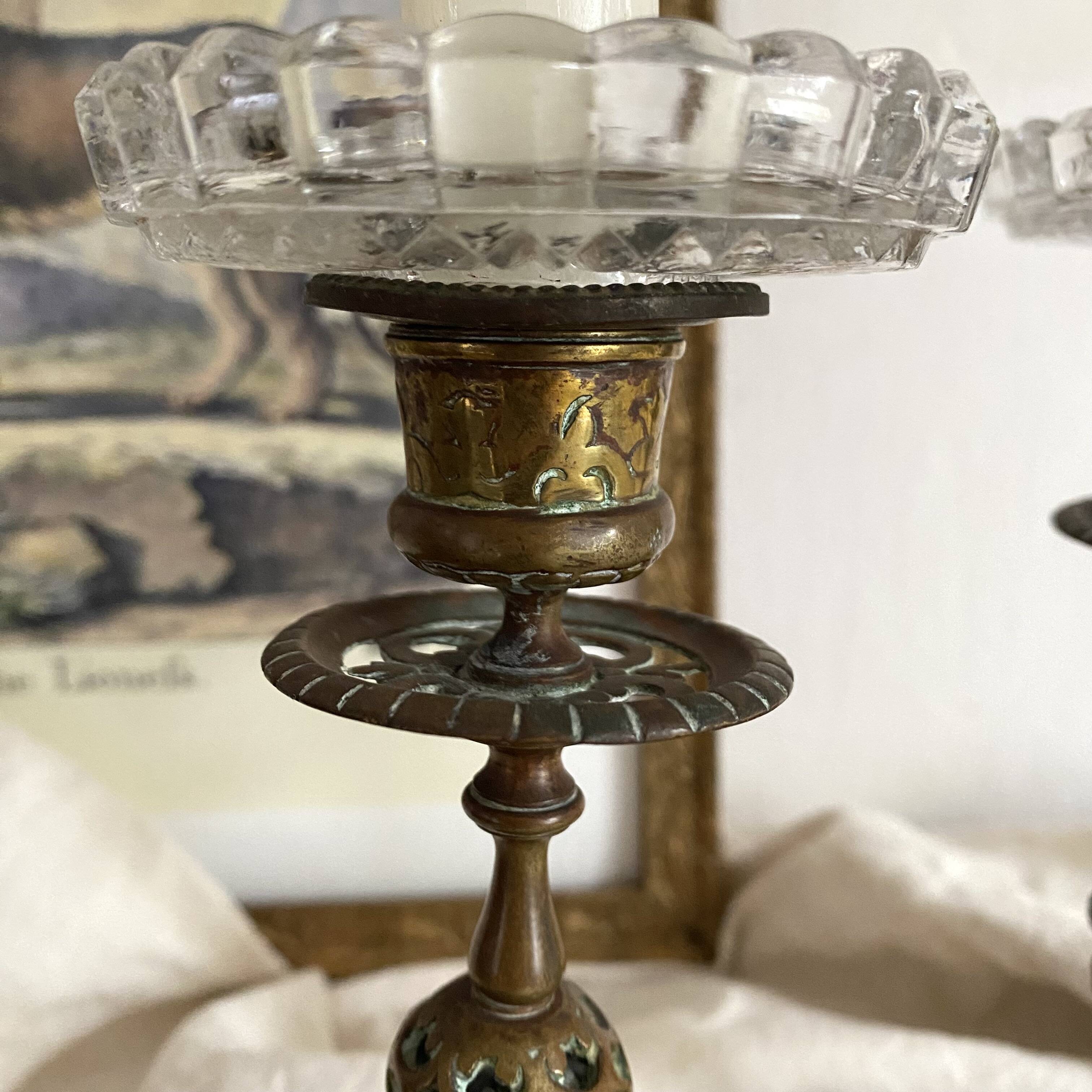 Pair of openwork brass candlesticks and glass bobeches
