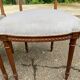 2 Louis XVI period chairs in solid wood and grey fabric.