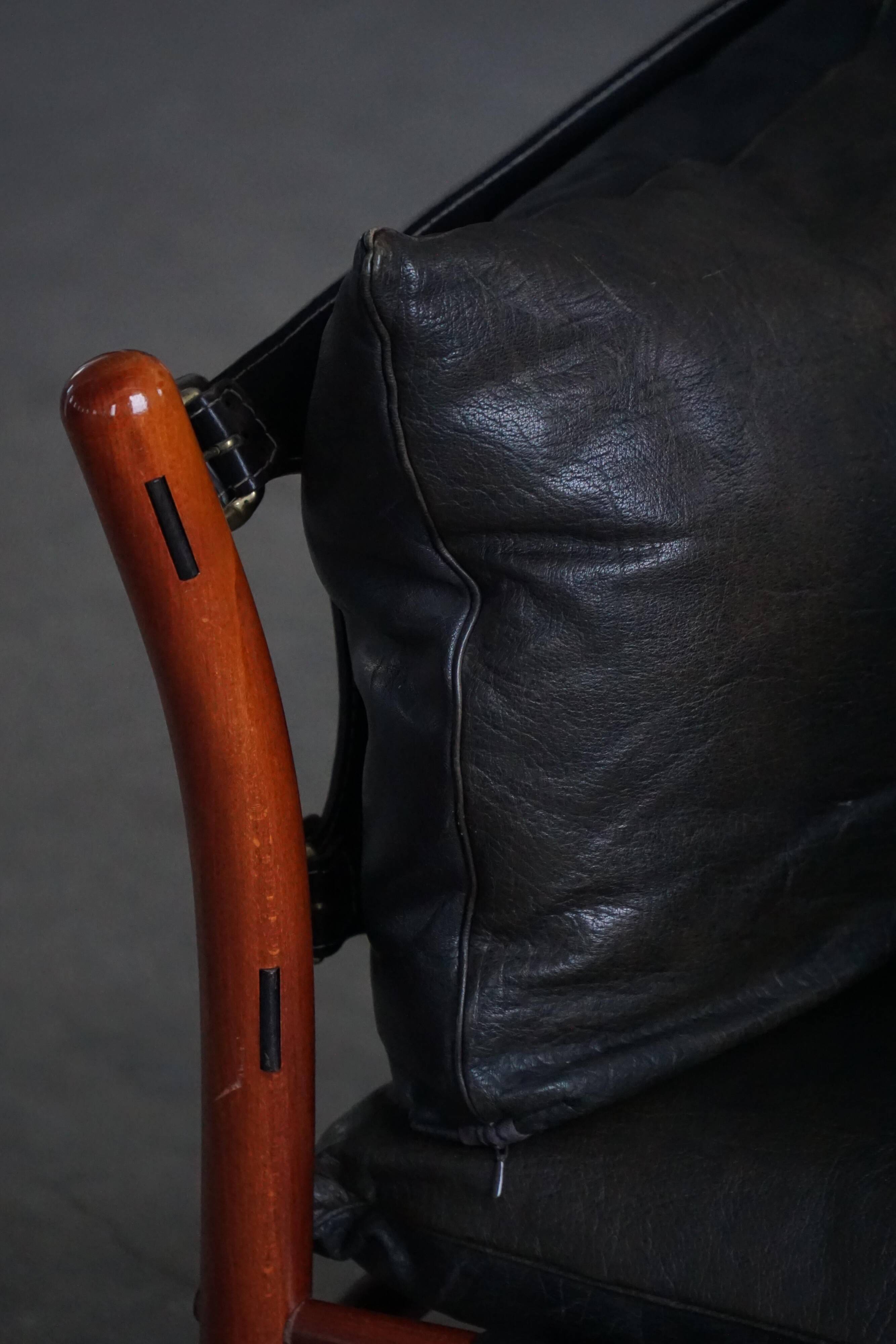 "Lounge chair 'Ilona' by Arne Norell in stained beech and leather, mid-20th century."