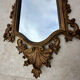 Carved and gilded wooden wall mirror.