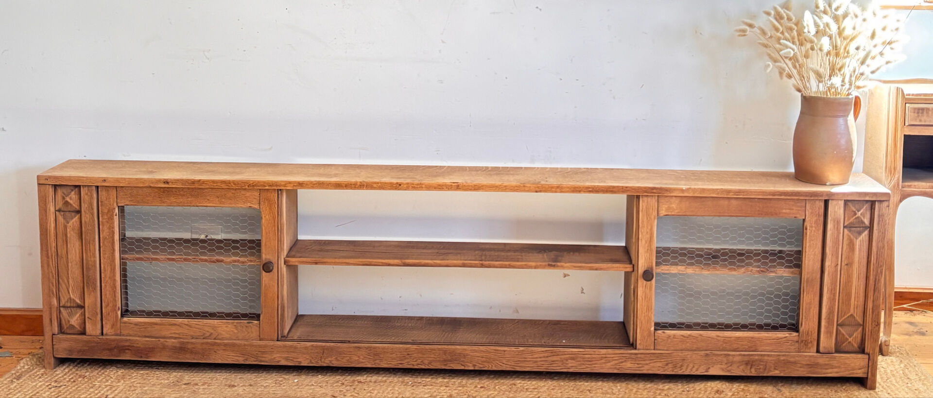 Vintage oak sideboard TV unit with sliding doors.