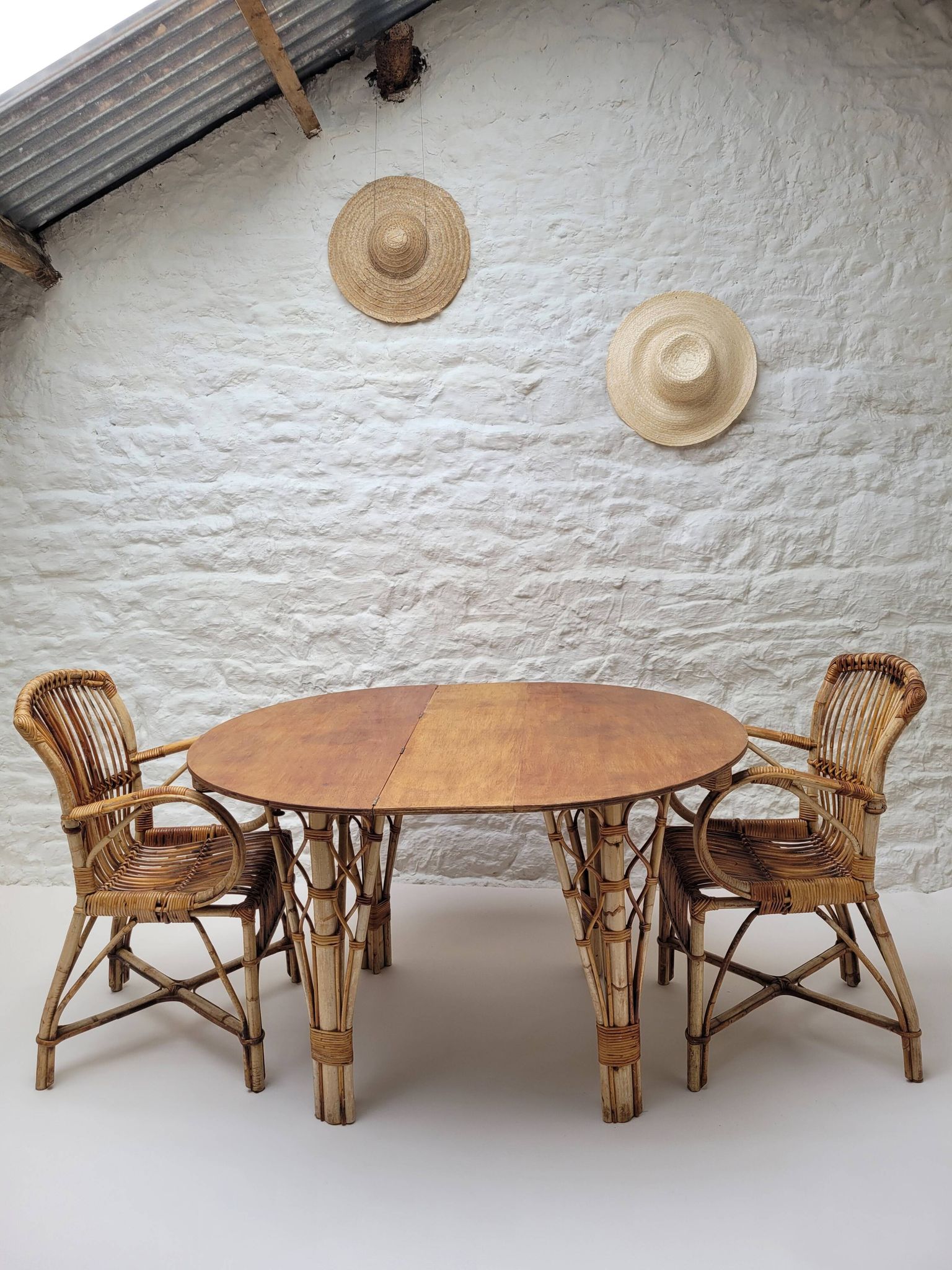Vintage Audoux Minet bamboo, rattan, and smoked glass table duo.