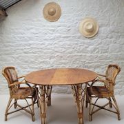 Vintage Audoux Minet bamboo, rattan, and smoked glass table duo.
