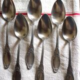 A set of 6 silver-plated metal soup spoons with foliage design.