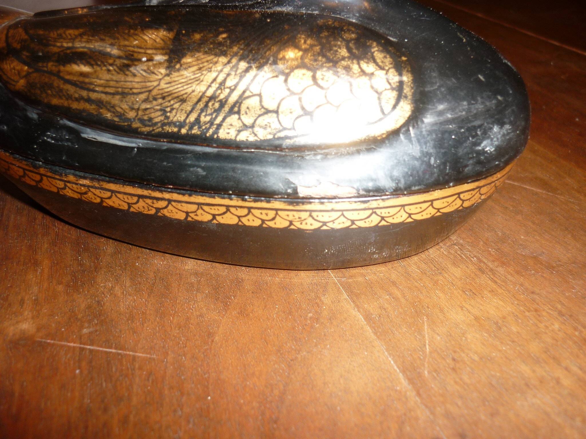 Black and gold wooden duck