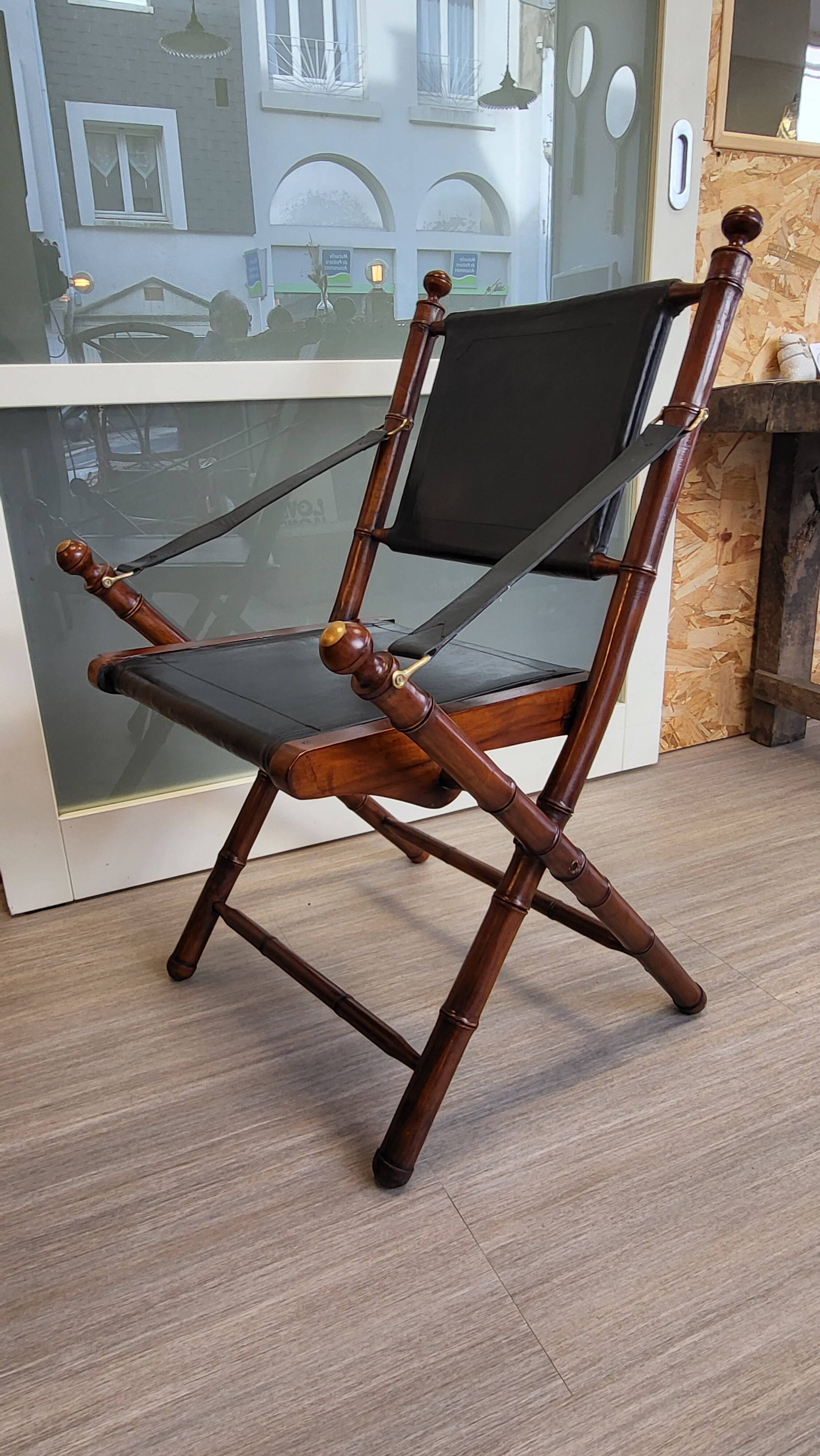 Colonial style folding leather and teak armchair