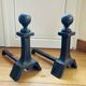 Pair of massive antique-style fire dogs in solid iron from the 20th century.