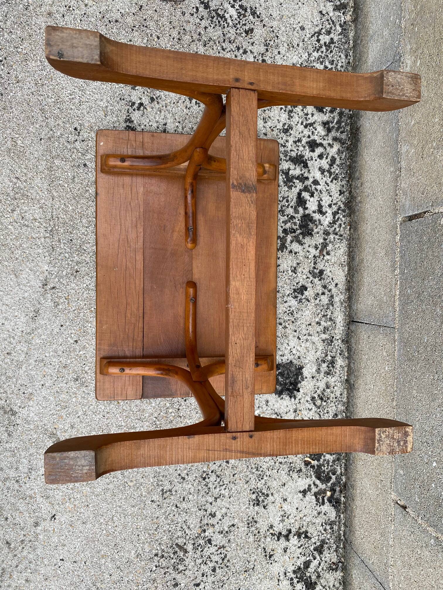Small side table or bistro serving table with curved wood.