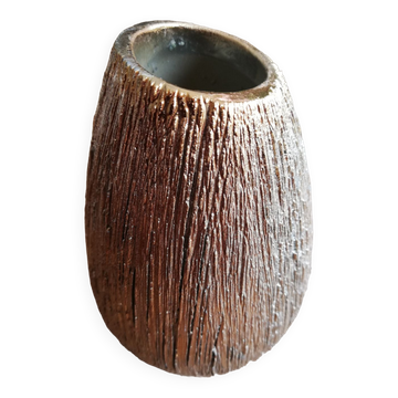 Small asymmetrical golden vase in the shape of a seed.