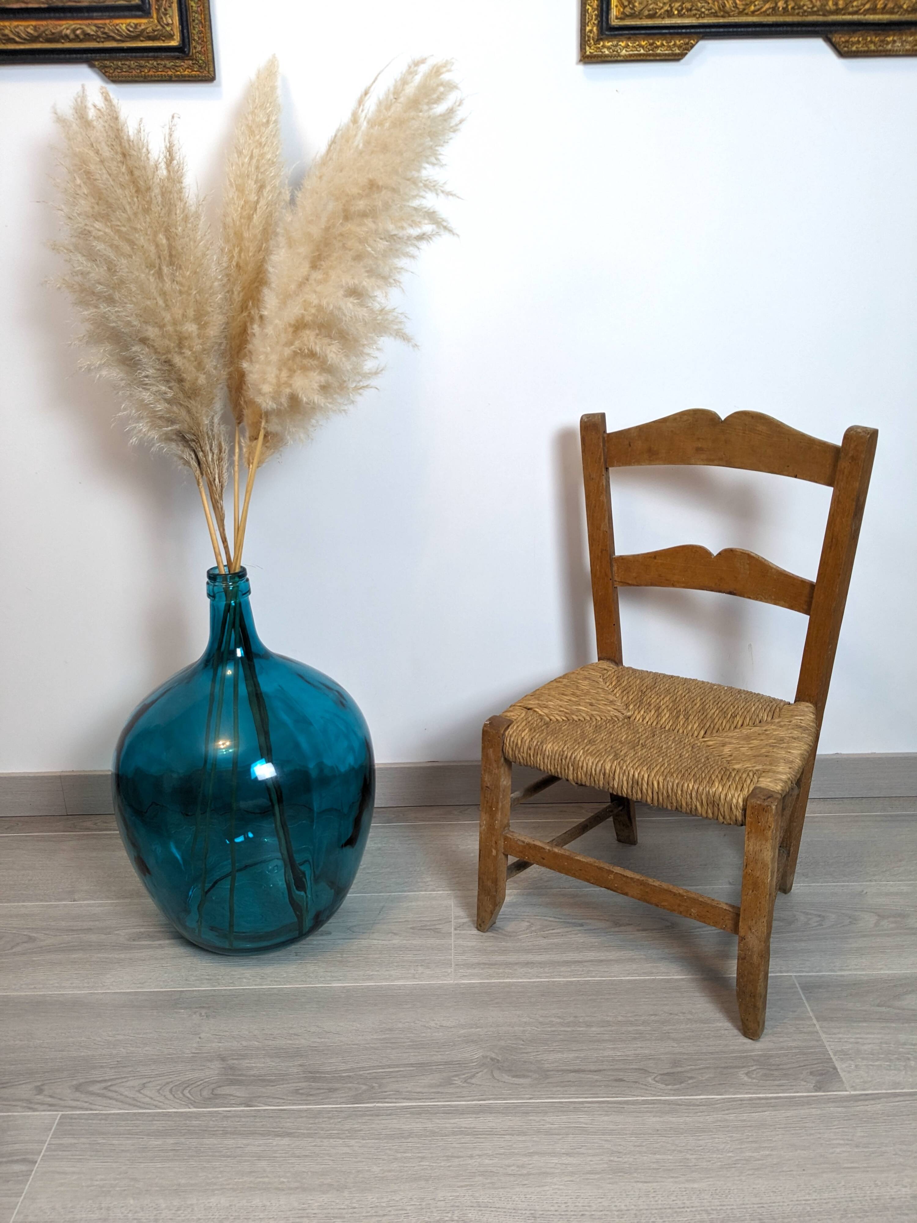 Vintage wooden and straw children's chair in a country style.