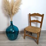 Vintage wooden and straw children's chair in a country style.