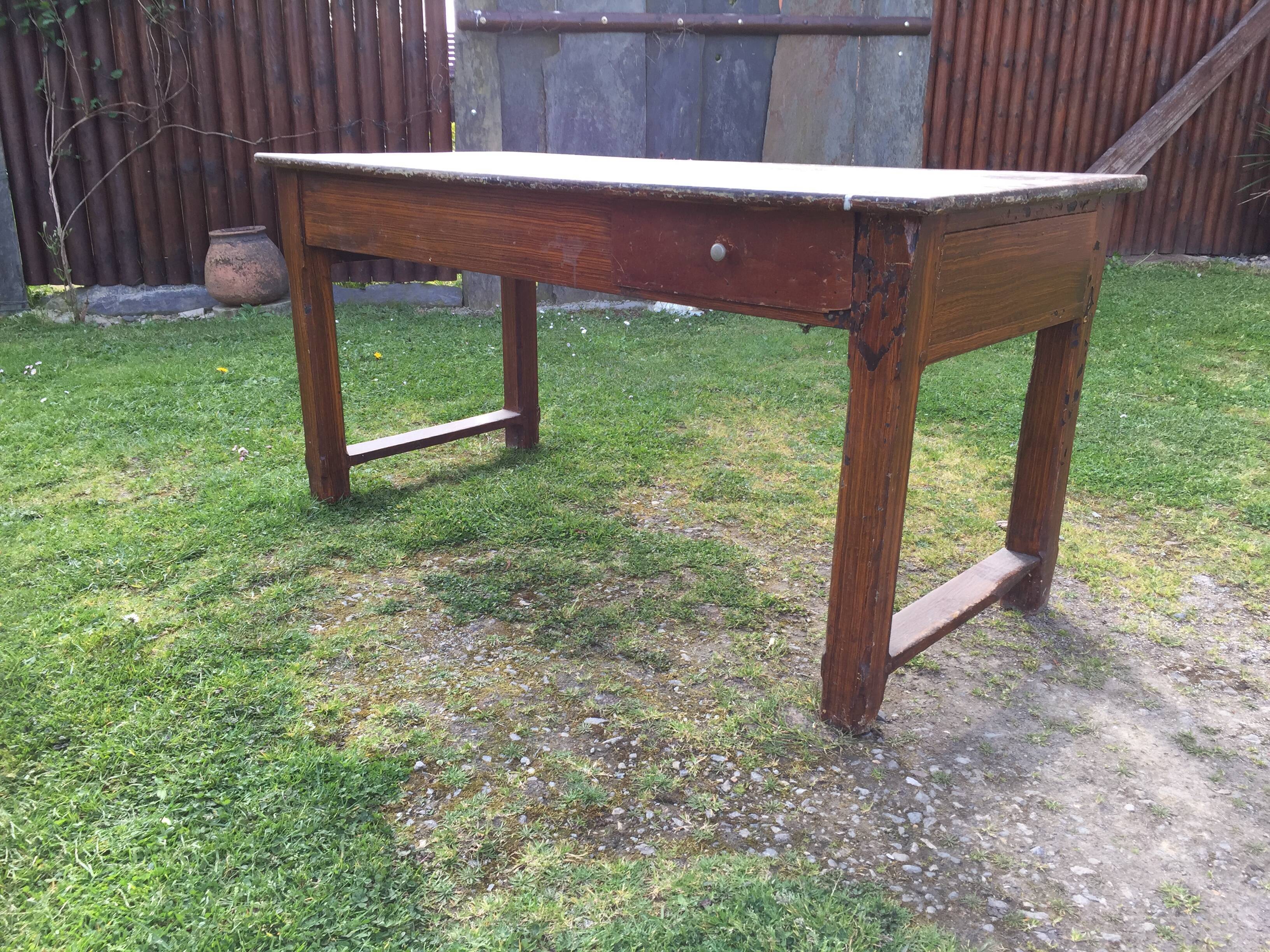 Old farmhouse table in oak painted faux wood old painting.