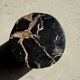 Black petrified wood side table with beige stripes, star pattern H35 D24.