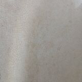 Large antique plate stamped with a fauna and flora pattern.