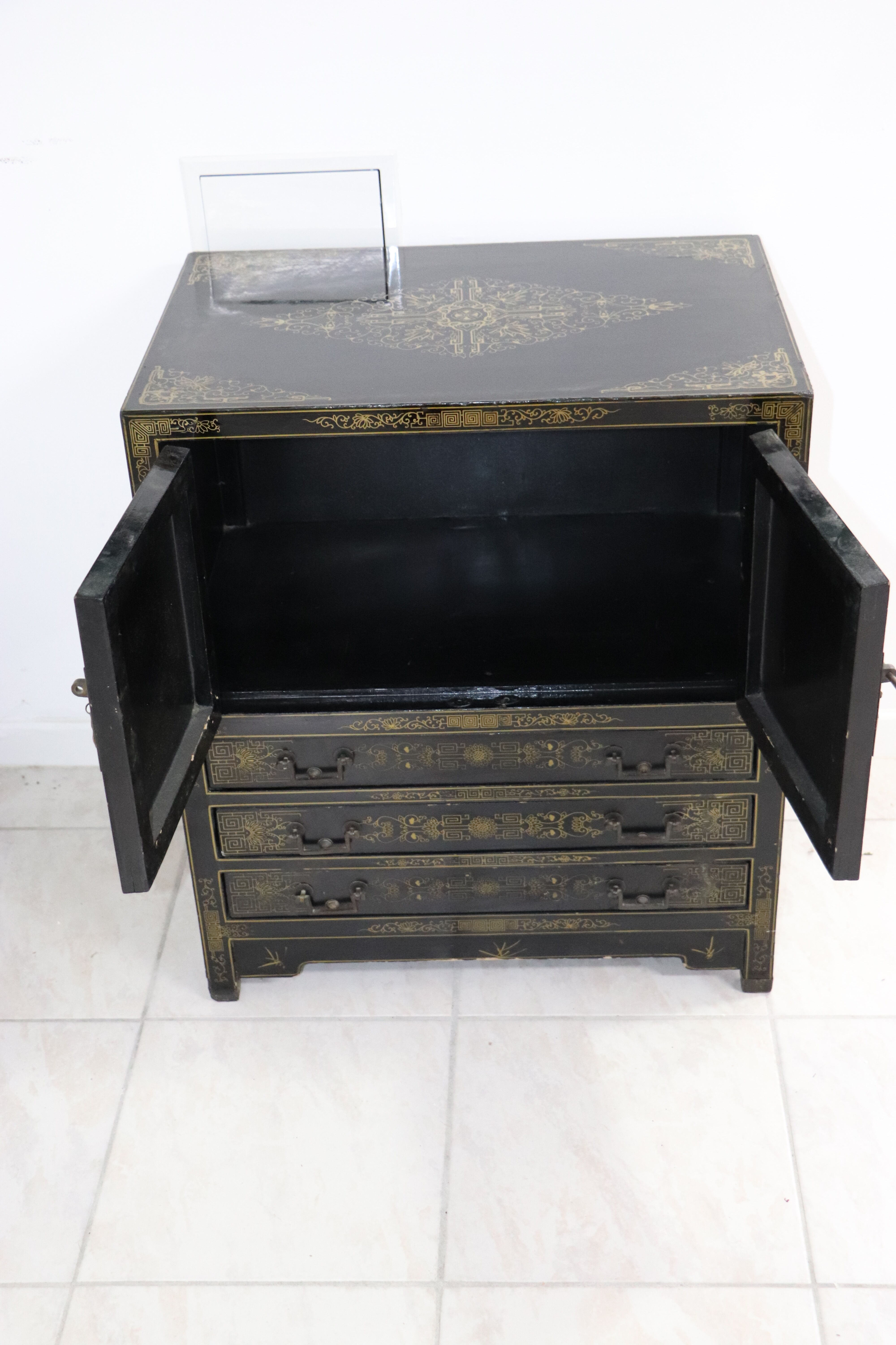 Black lacquered Chinese buffet with stone and ivory figures