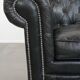 Black Chesterfield armchair made of grained cowhide leather