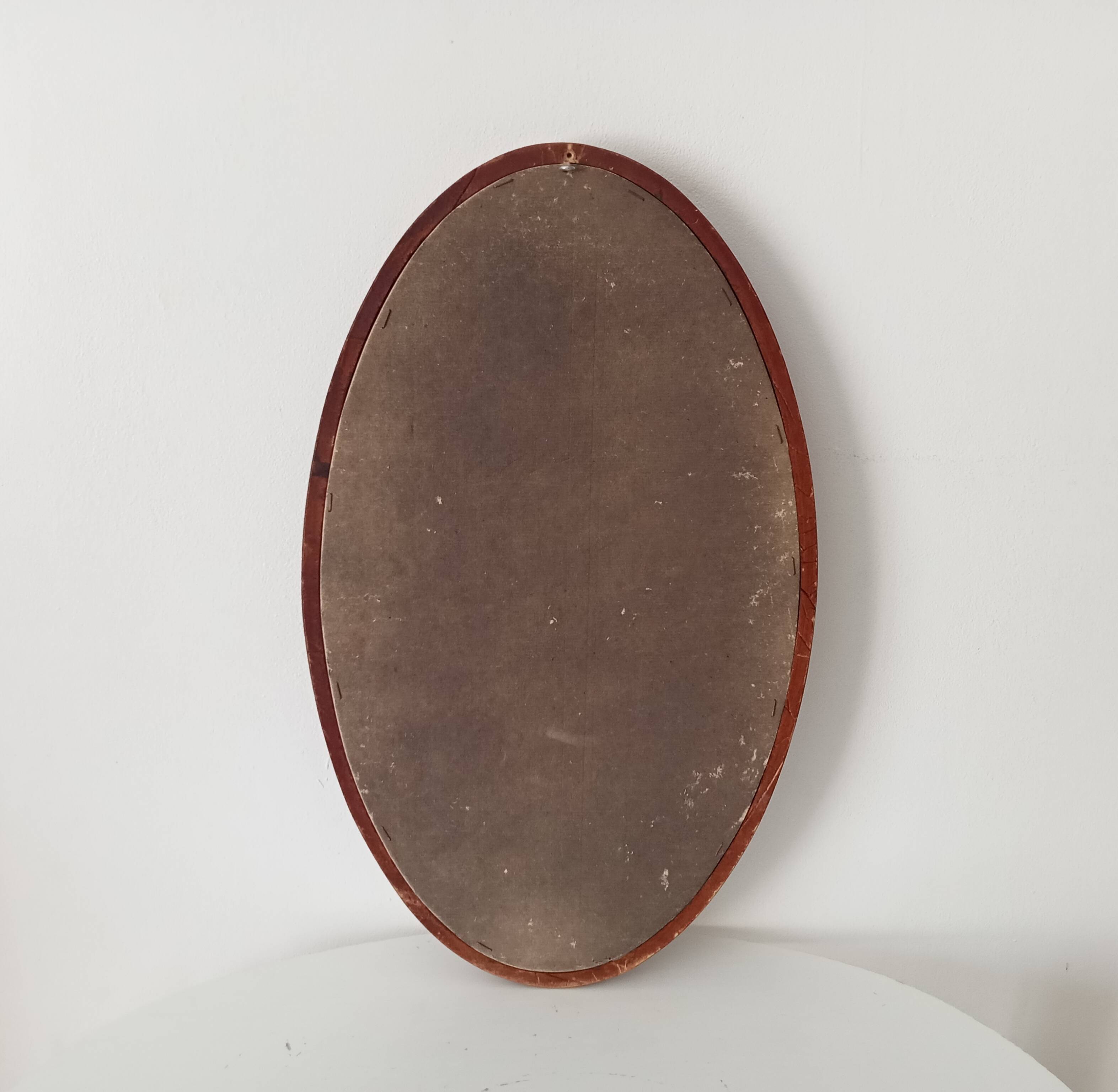 Vintage oval wooden mirror "caramel" from the 1960s.