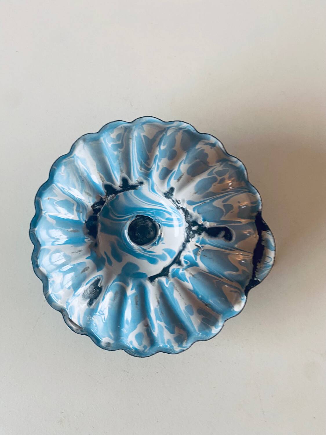 Old blue enameled metal candle holder