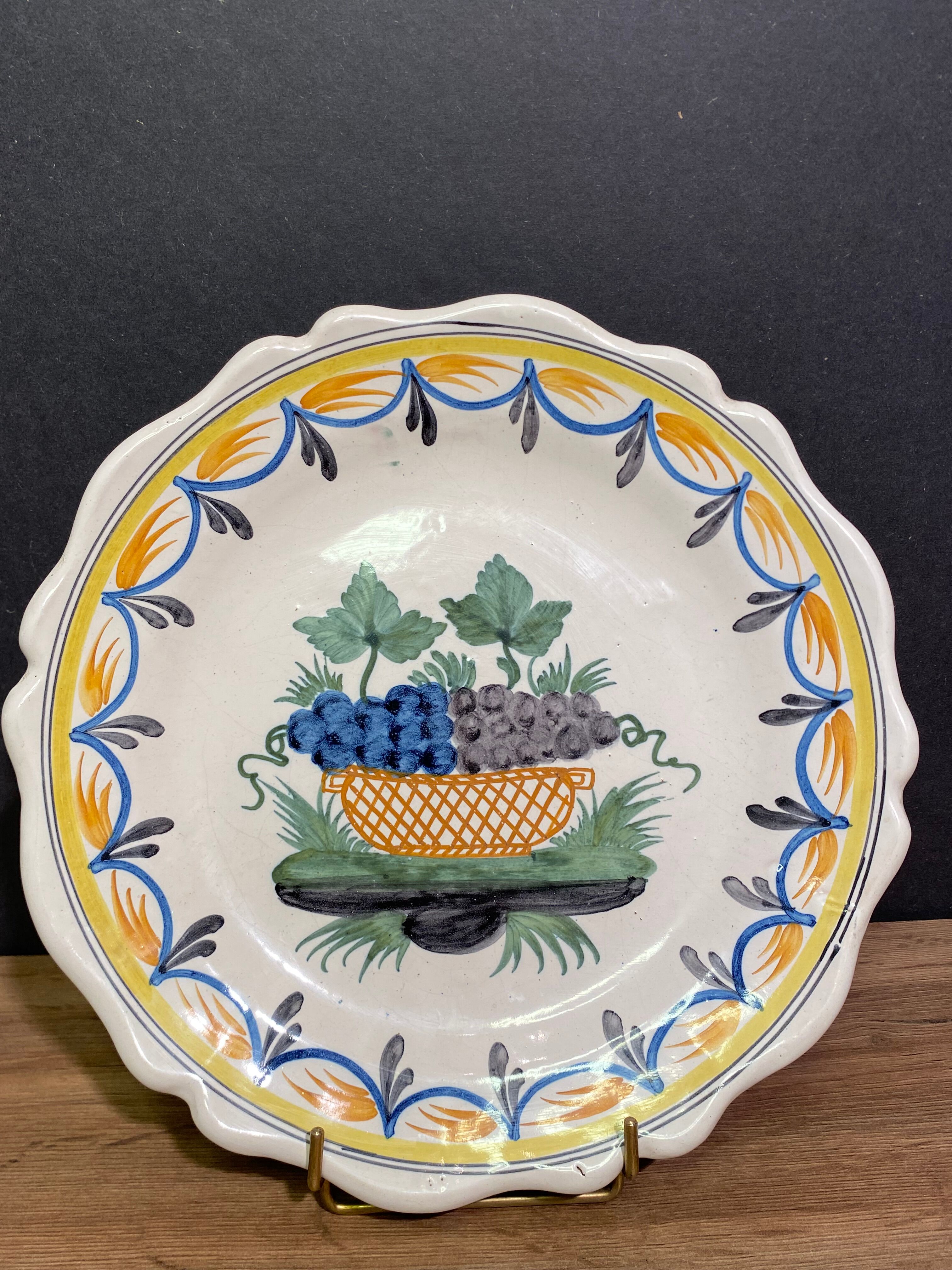 Faience dish of eighteenth-century style nevers decorated with basket with bunches of grapes