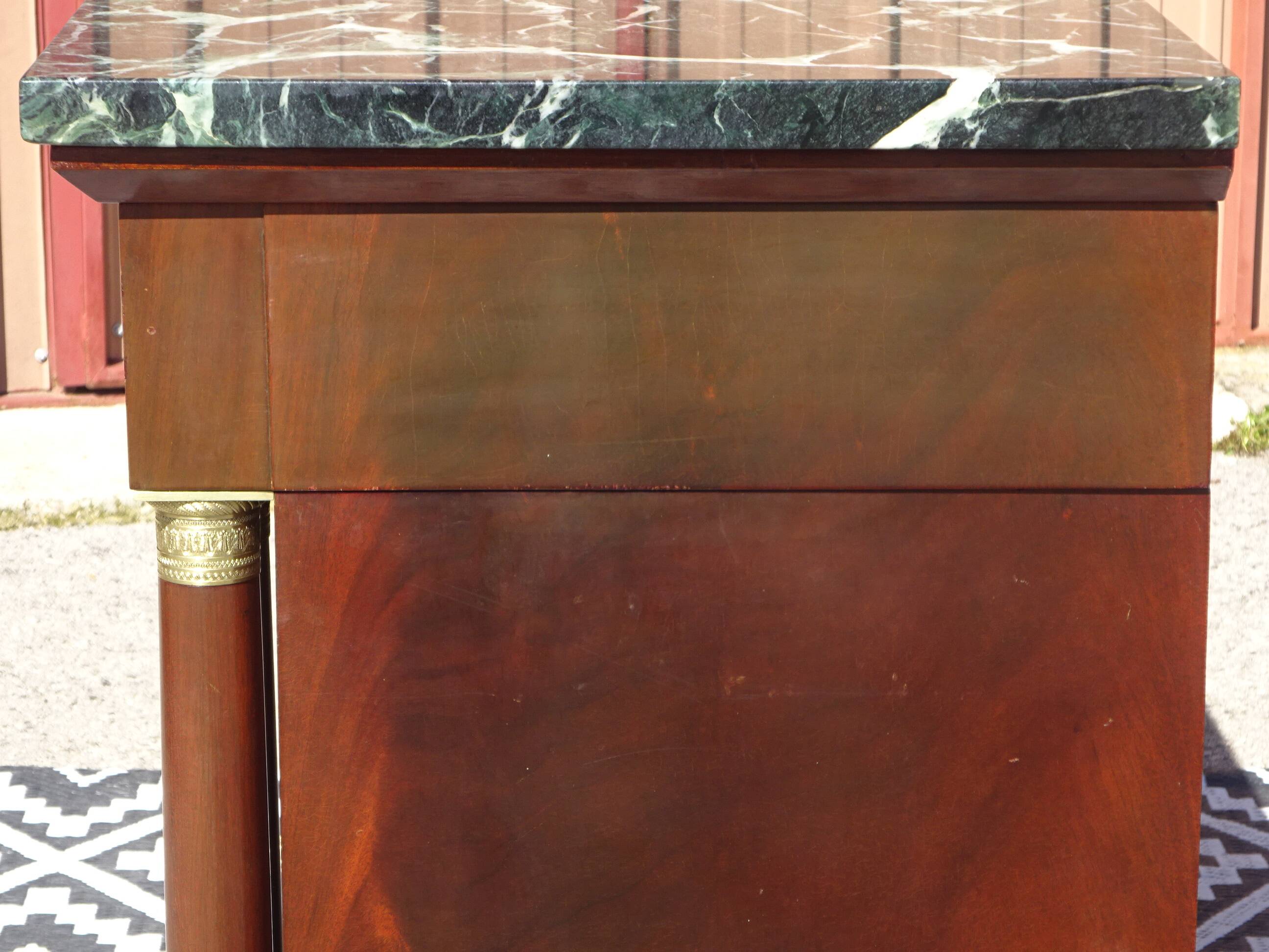 Flamed mahogany enfilade with sea green marble in Empire style.