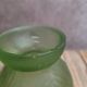 Small Art Deco round vase in moulded green pressed glass – relief decoration