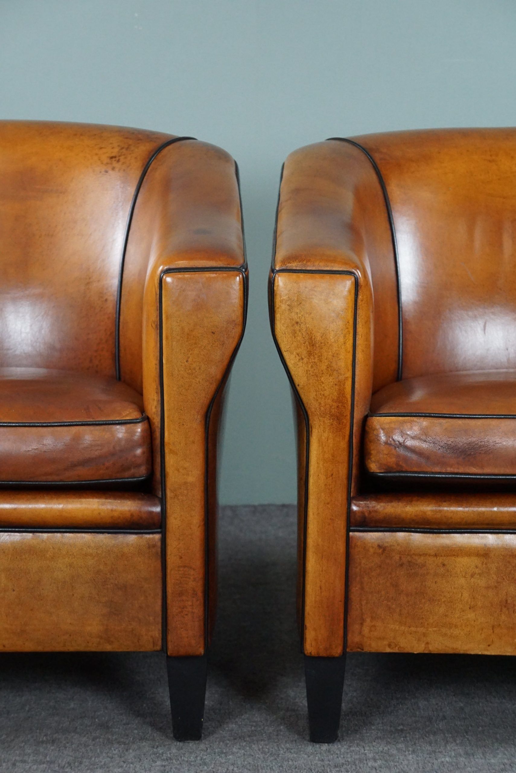 Set de 2 fauteuils Art Déco en cuir de mouton passepoil noir