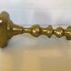 Brass candlestick with a rectangular base.