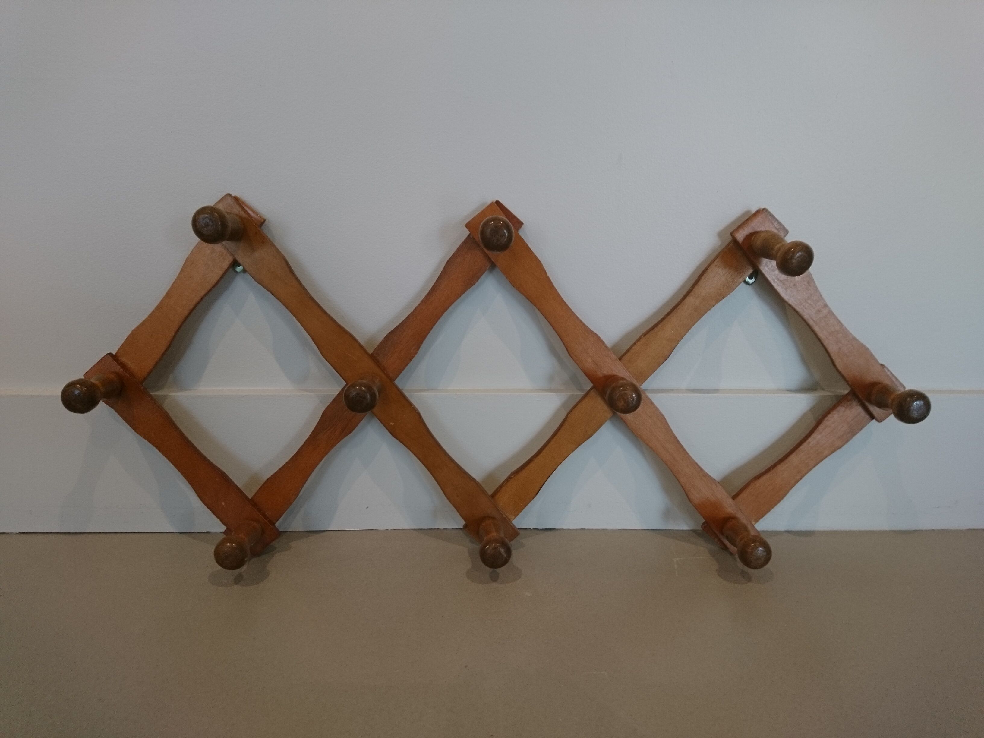 Folding wall coat rack