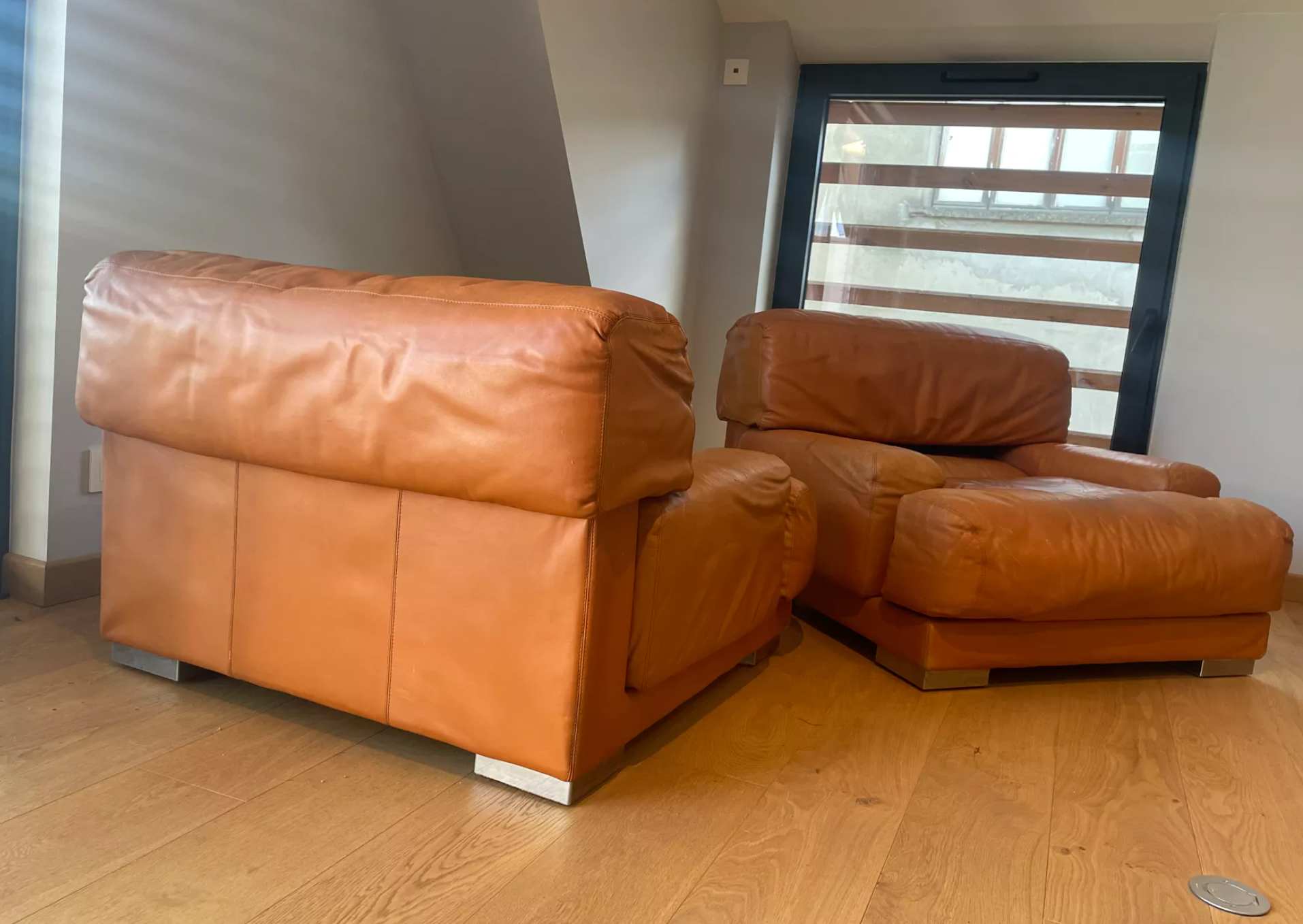 Pair of vintage armchairs Gérard Guermonprez tawny leather and stainless steel, France 1970