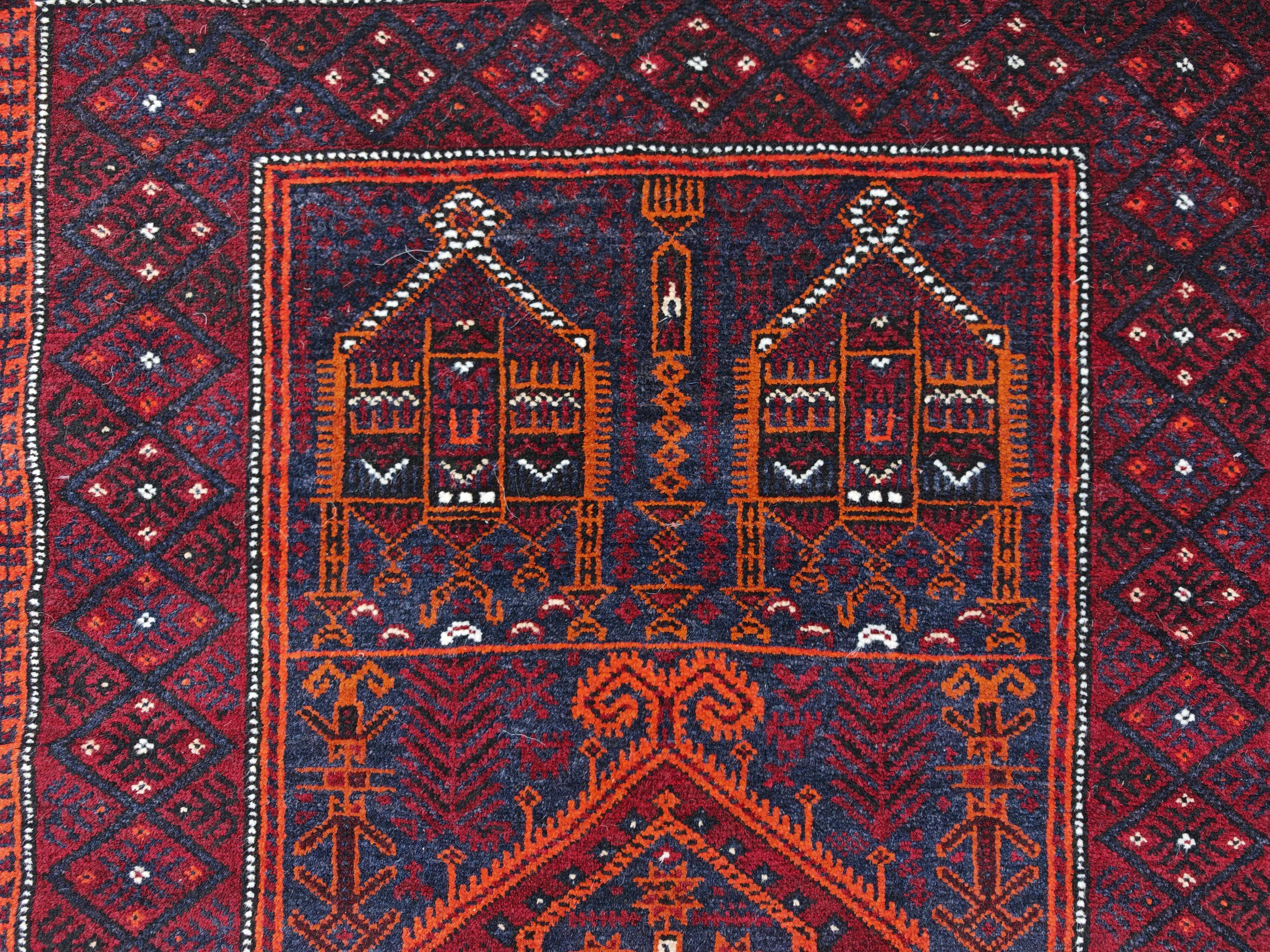 Vintage hand-knotted Persian Baluch prayer rug from the 1940s.
