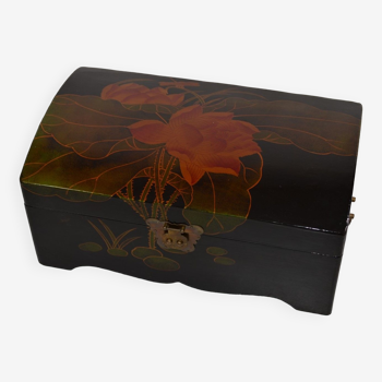 Lacquered wooden box decorated with lotus leaves and flowers on a black background