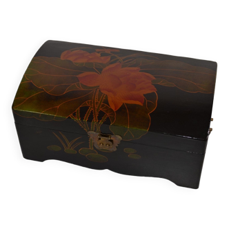 Lacquered wooden box decorated with lotus leaves and flowers on a black background