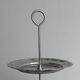 Three-tiered serving trolley in shiny stainless steel.